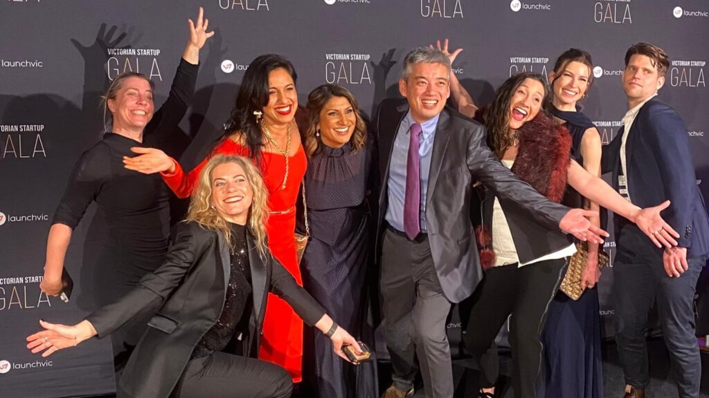 8 people (LtR: Petra Andren, Louise Schaper, Grace Mathew, Amandeep Hansra, Bi Mian, Kim Drever, Annie Chapman, Richard Macliver) posing for a photo at the Victorian Startup Gala